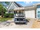 Rear view of a blue golf cart parked in front of a home with a two-car garage at 9758 Sw 94Th Ave # A, Ocala, FL 34481