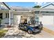 A blue golf cart parked in front of a well-maintained house with a lush green lawn at 9758 Sw 94Th Ave # A, Ocala, FL 34481