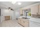 Bright, open kitchen with tile floors, wooden cabinets, white countertops, and modern appliances at 9758 Sw 94Th Ave # A, Ocala, FL 34481
