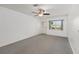 Neutral carpet, ceiling fan, and front door in this bright living room at 9758 Sw 94Th Ave # A, Ocala, FL 34481