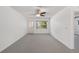 Bright open living room with neutral carpet and a ceiling fan at 9758 Sw 94Th Ave # A, Ocala, FL 34481