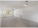 Open living room with a decorative front door, a ceiling fan, and neutral carpet at 9758 Sw 94Th Ave # A, Ocala, FL 34481