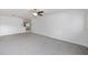 Large living room features neutral carpet, ceiling fan, and bright natural light at 9758 Sw 94Th Ave # A, Ocala, FL 34481