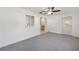 Inviting living room with neutral carpet, access to the kitchen, and sliding door to the outside at 9758 Sw 94Th Ave # A, Ocala, FL 34481
