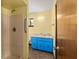Bathroom with shower stall, blue cabinet, marble-look countertop, and a window at 10197 Sw 88Th Ter, Ocala, FL 34481