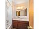 Bathroom featuring a tub with shower, vanity with dark wood cabinet and mirror at 10197 Sw 88Th Ter, Ocala, FL 34481