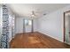 Bedroom with hardwood floors, ceiling fan and an entrance to hallway at 10197 Sw 88Th Ter, Ocala, FL 34481