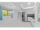 Bright kitchen and dining area featuring modern stainless steel appliances, white cabinets, and marble floors at 10197 Sw 88Th Ter, Ocala, FL 34481