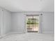 Bright living room featuring sleek marble floors and sliding door access to outdoors at 10197 Sw 88Th Ter, Ocala, FL 34481