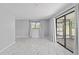 Light and airy living room featuring marble floors, big windows, and access to sun room at 10197 Sw 88Th Ter, Ocala, FL 34481