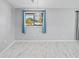 Bright and airy living area featuring large windows, stylish light fixture, and modern marble floors at 10197 Sw 88Th Ter, Ocala, FL 34481