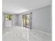 Spacious living room featuring bright white marble floors and lots of light at 10197 Sw 88Th Ter, Ocala, FL 34481