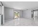 Bright and airy living area featuring a sliding glass door, neutral walls, and modern marble floors at 10197 Sw 88Th Ter, Ocala, FL 34481