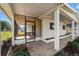 Covered and screened in sun room featuring tile entryway and white support columns at 10197 Sw 88Th Ter, Ocala, FL 34481