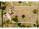 A bird's-eye view of the vast land surrounding a home with solar panels, featuring open fields and wooded borders at 10631 W Highway 40, Ocala, FL 34482