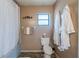 Full bathroom features bathtub with shower, a toilet and charming décor at 10631 W Highway 40, Ocala, FL 34482
