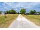 Gravel driveway leading to the property and offering a rural setting at 10631 W Highway 40, Ocala, FL 34482