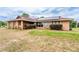 Charming home featuring stone detailing, manicured bushes, and a welcoming front lawn at 10631 W Highway 40, Ocala, FL 34482