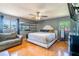 Spacious main bedroom features hardwood floors, ceiling fan and a mirrored wall at 10631 W Highway 40, Ocala, FL 34482