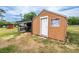 A shed with an overhang is on a lot that is in need of some lawn care at 10631 W Highway 40, Ocala, FL 34482