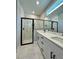 Modern bathroom featuring a glass shower with black trim and a double sink vanity with white countertop at 13081 Sw 78Th Cir, Ocala, FL 34473