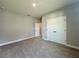 Carpeted bedroom features a double closet and doorway leading to another room at 13081 Sw 78Th Cir, Ocala, FL 34473