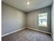 Neutral bedroom featuring plush carpet, a single window, and fresh paint at 13081 Sw 78Th Cir, Ocala, FL 34473
