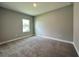 Carpeted bedroom with a window features baseboards at 13081 Sw 78Th Cir, Ocala, FL 34473