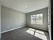 Carpeted bedroom features a large window with view of the neighborhood at 13081 Sw 78Th Cir, Ocala, FL 34473