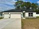 Beautiful single story home featuring an attached three-car garage and well-maintained lawn at 13081 Sw 78Th Cir, Ocala, FL 34473
