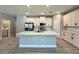 Open-concept kitchen with a large center island, white cabinets, and stainless steel appliances at 13081 Sw 78Th Cir, Ocala, FL 34473