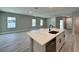 The open layout features an eat-in kitchen and living room combo with light, airy colors at 13081 Sw 78Th Cir, Ocala, FL 34473