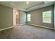 Large main bedroom with plush carpet and natural light from the windows at 13081 Sw 78Th Cir, Ocala, FL 34473