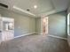 Spacious main bedroom offers plush carpeting, tray ceilings, and recessed lighting at 13081 Sw 78Th Cir, Ocala, FL 34473