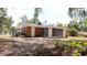 Exterior back view of the home with an enclosed porch and large yard at 1335 Ne 10Th St, Ocala, FL 34470