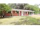 Charming brick home with covered front porch and beautifully manicured lawn at 1335 Ne 10Th St, Ocala, FL 34470