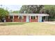Charming brick home with covered front porch, carport, and large front yard at 1335 Ne 10Th St, Ocala, FL 34470