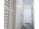 Bright hallway with gray vinyl floors, storage closet, and white doors at 1335 Ne 10Th St, Ocala, FL 34470