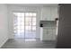 Updated kitchen with white cabinets and sliding door to the enclosed back porch at 1335 Ne 10Th St, Ocala, FL 34470