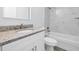 Stylish bathroom featuring granite countertops, a bathtub and shower combo, and modern finishes at 13493 Sw 112 Pl, Dunnellon, FL 34432