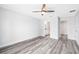 Bright bedroom with grey flooring and two entryways and ceiling fan at 13493 Sw 112 Pl, Dunnellon, FL 34432