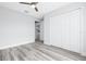 Bright bedroom with grey flooring and a ceiling fan and white closet doors at 13493 Sw 112 Pl, Dunnellon, FL 34432