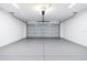 Clean, painted two-car garage with automatic door opener and overhead lighting at 13493 Sw 112 Pl, Dunnellon, FL 34432