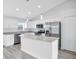 Bright kitchen features white cabinets, stainless steel appliances, light countertops and a large island at 13493 Sw 112 Pl, Dunnellon, FL 34432