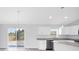 Bright open floor plan kitchen with white cabinets, stainless steel appliances and granite island at 13493 Sw 112 Pl, Dunnellon, FL 34432