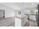 Open-concept kitchen with a center island, stainless steel appliances, and sliding glass doors at 13493 Sw 112 Pl, Dunnellon, FL 34432