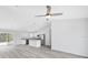 Open-concept home with wood-look floors, flowing from living area to kitchen and sliding glass doors at 13493 Sw 112 Pl, Dunnellon, FL 34432