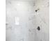 Shower featuring white marble-look tiling and a bronze shower head at 13493 Sw 112 Pl, Dunnellon, FL 34432
