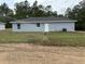 View of backyard with new construction home featuring recently installed lawn and sprinkler at 14437 Sw 21St Pl, Ocala, FL 34481