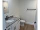 Well-lit half-bath with granite countertop, modern sink, and new hardwood floors at 14437 Sw 21St Pl, Ocala, FL 34481